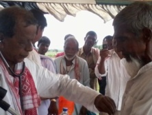 Dr. Bhumidhar Barman treating people.