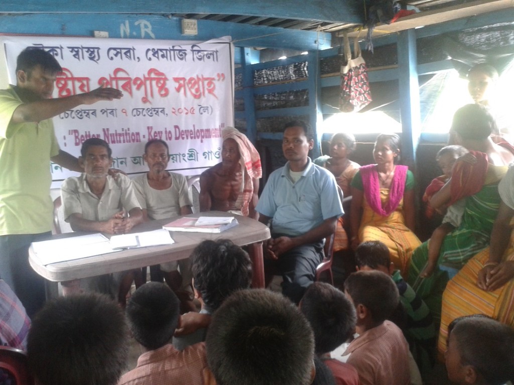 Medical Officer, Dhemaji Boat Clinic Dr Rahul Mistri interacting with villagers of Sirangshree village, on board the Boat Clinic on the occasion of the Food and Nutrition Week in September 2015