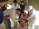 The DC giving polio drops to a child