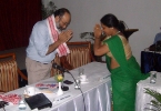 Monjurani Dutta Thakur, Angadwadi worker from Dergaon felicitating Sanjoy Hazarika with a woven gamocha , at the seminar.