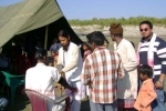 A health Team in progress at Erasuti Garamjan, (a Tinsukia river island) on 28 Dec which the Aiyars attended. Rustom Aiyar (with Gamosa) looks on with keen interest.