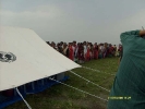 Women and children wait for their turn for the health check up in an orderly queue even as the shooting takes place of the camp in progress.