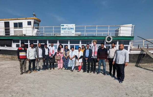 The visitors with the Kamrup Boat Clinic team with Boat Clinic Kaliyani as backdrop